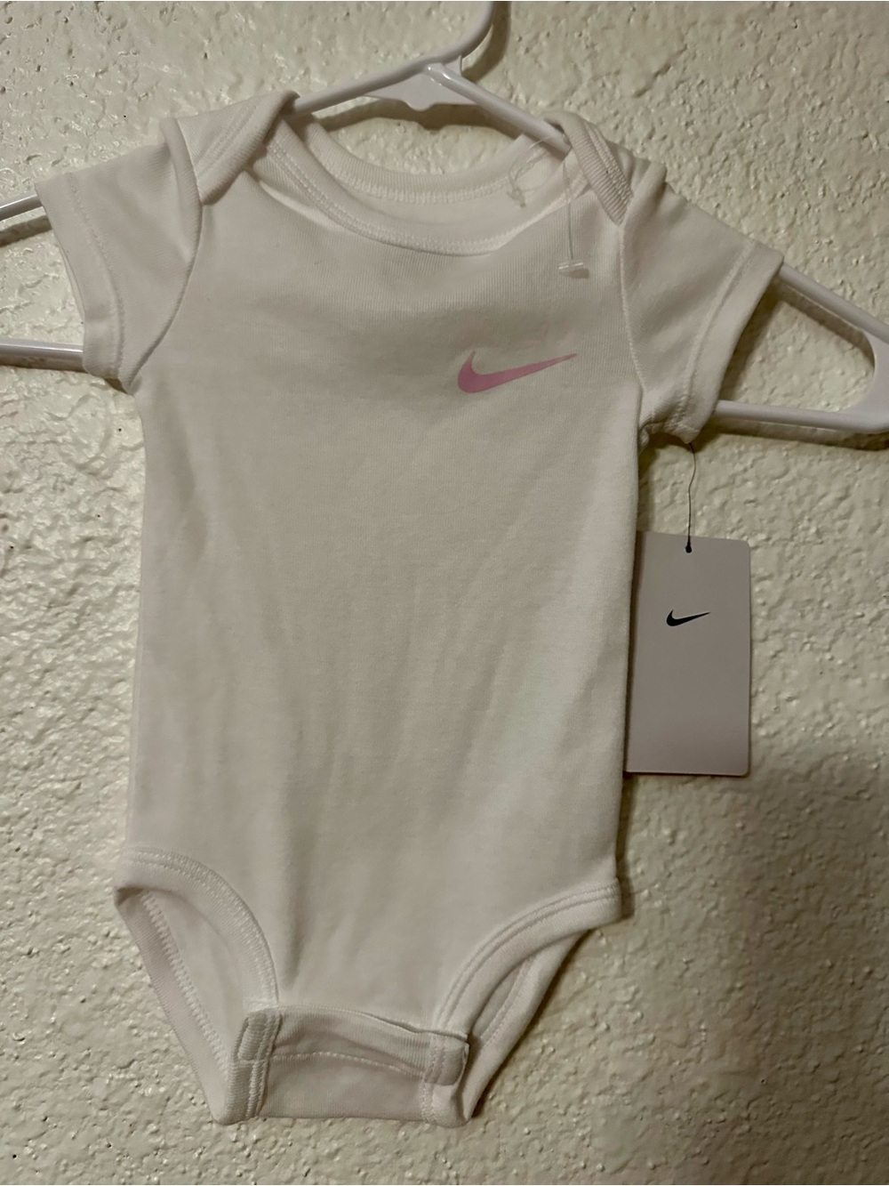 Nike White Infant Onesie with Pink Accent